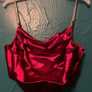 Red shiny corset with rhinestone straps and back zipper.